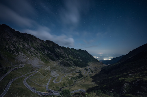 Amazing night view with clear starry sky of the north part of famous Transfagarasan serpentine mountain road between Transylvania and Muntenia in Romania