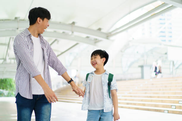 istock Boy and his father in city. 1470261847