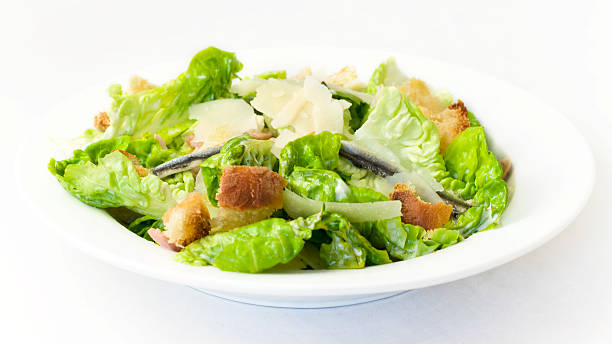 Healthy Caesar Salad Healthy Caesar Salad with anchovies and parmesan cheese Caesar Dressing stock pictures, royalty-free photos & images