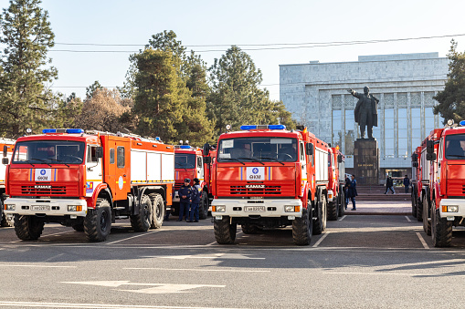 Bishkek, Kyrgyzstan - February 28, 2023: Ministry of Emergency Situations of Kyrgyzstan receiving a new firetrucks with Vladimir Lenin monument in the background