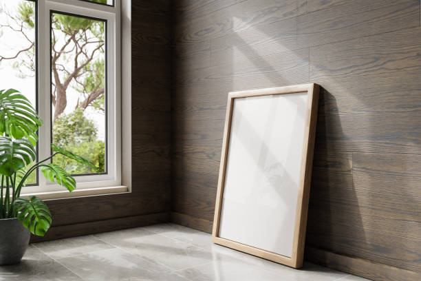 istock single empty canvas poster mock up leaning on wall; bright daylight shining through a large window; home decoration desing; 3D Illustration 1470270080