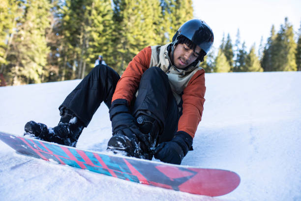 istock A multiracial man buckling his snowboard on a slope 1470270149