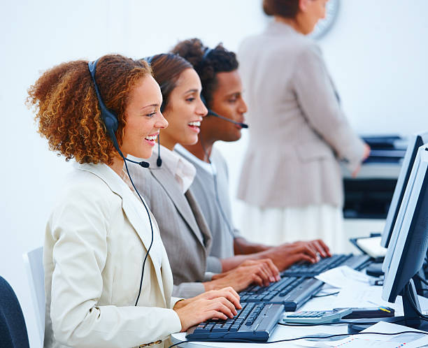 istock Business executives sitting with headsets and using laptop 147027015