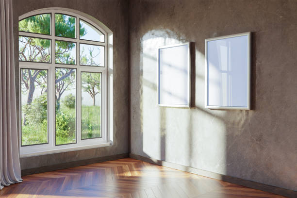 istock empty canvas poster mock up hanging on a wall; empty living room interior; bright daylight shining through a large window; home decoration desing; 3D Illustration 1470270467