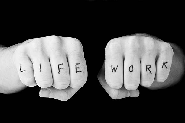 istock Two fists with the words LIFE WORK written on each finger 147027103
