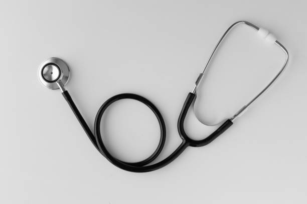 Stethoscope lies on white desk - top view, raw developed studio shot with full frame camera