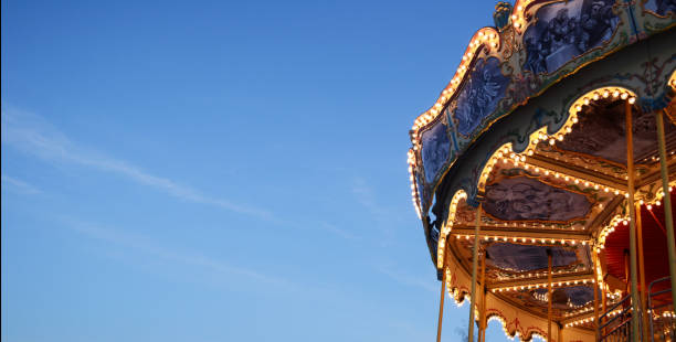 istock bright background, banner sky and carousel, amusement park, glowing carousel 1470273876