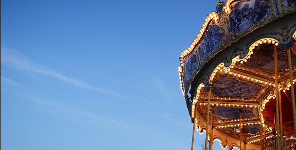 bright background, banner sky and carousel, amusement park, glowing carousel