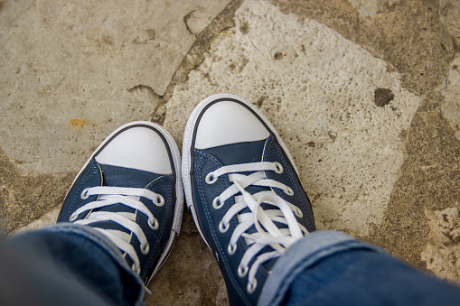 Women's feet in red sneakers