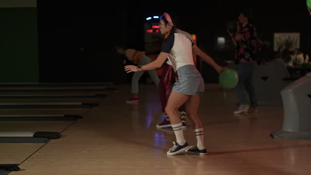 Friends bowling together