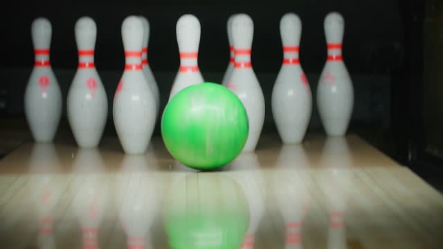 A bowling ball strikes