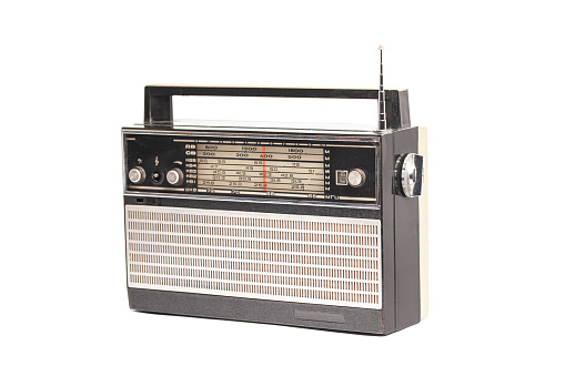 Old transistor radio isolated on white.