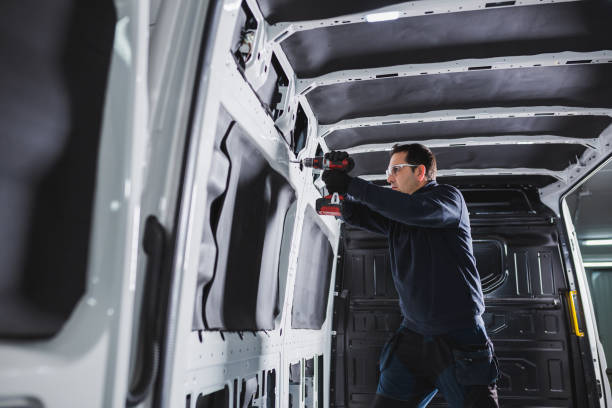 istock Converting a van into a home on wheels. Man working with a battery-powered drill inside a van. 1470278861