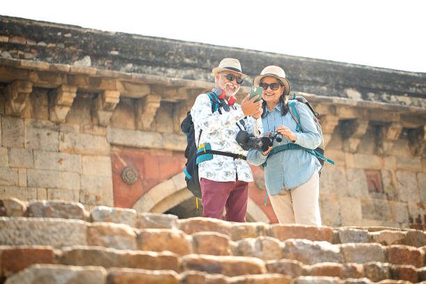 istock Senior couple tourist using phone on vacation post retirement 1470280358