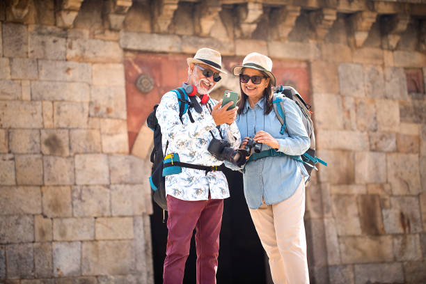 istock Senior couple tourist using phone on vacation post retirement 1470280464