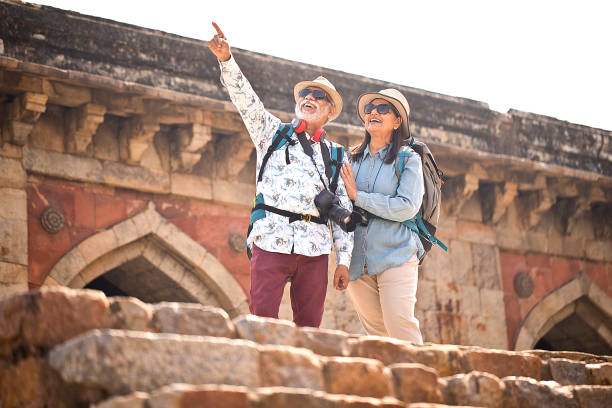 istock Old couple tourist looking up at ancient architecture 1470280513