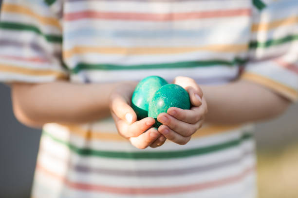 istock Close up of two dyed eggs in childs hands. 1470280999