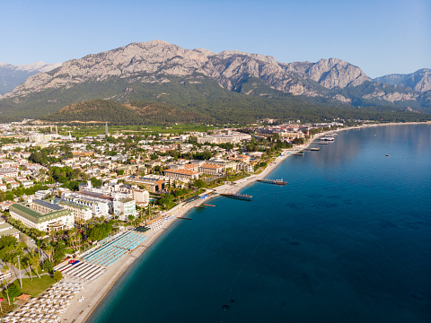 Scenic drone view of popular Turkish seaside resort city of Kemer located on Mediterranean coast in Gulf of Antalya on background of Taurus Mountain range
