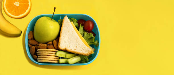 istock School lunch in the box on the yellow background. Top view. Copy space. 1470285854