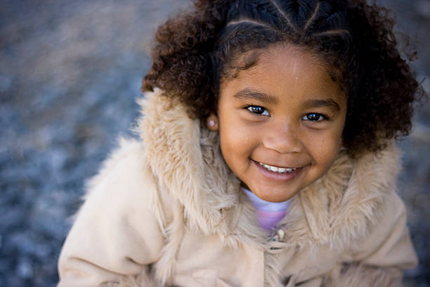 Cute mixed race little girl Cute african american little girl kids winter coat stock pictures, royalty-free photos & images