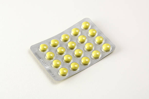 Pills in yellow color stock photo