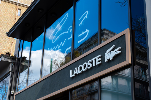 Boulogne-Billancourt, France - February 28, 2023: Exterior view of a Lacoste store, a French company specializing in the design and sale of clothing, shoes, accessories and perfumes
