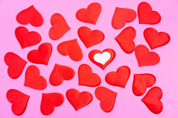 istock Bright red randomly scattered red hearts on a pink background. A declaration of love. 1470291120