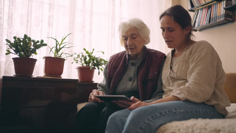 A helping hand. Helping grandma use the internet.