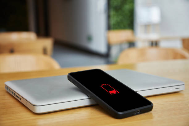 istock Mobile phone with no power on the dining table 1470292320