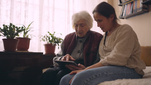 A helping hand. Helping grandma use the internet.