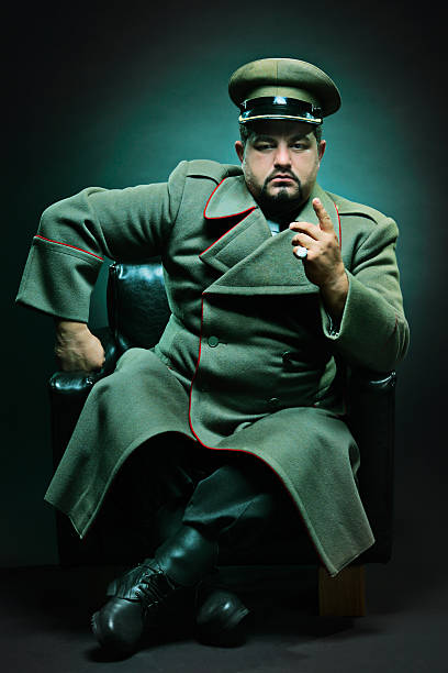The evil dictator The evil dictator sitting in a chair officer boots stock pictures, royalty-free photos & images