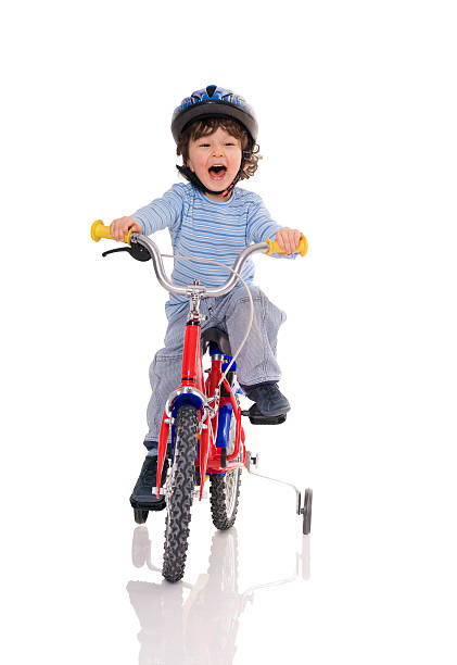 A young boy riding his first bicycle Little boy riding bicycle tricycle stock pictures, royalty-free photos & images
