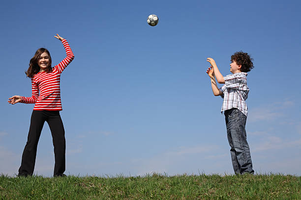 istock Kids playing ball outdoor against blue sky 147029636