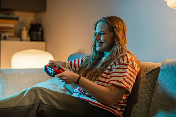 istock Young woman playing video games 1470299042