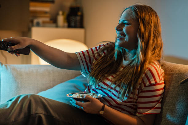 istock Young woman watching TV 1470299043