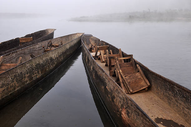 istock Three boats in misty river, Chitwan, Nepal 147029957