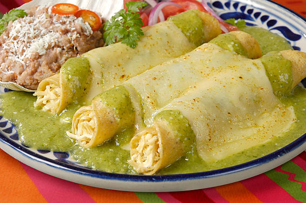 Enchiladas filled with cheese and covered in green sauce Real Mexican enchiladas taken by mexican food photographer enchilada stock pictures, royalty-free photos & images