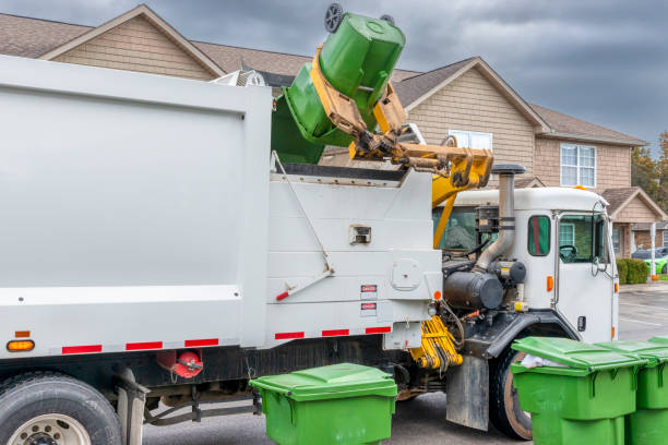 Mechanical Arm On Modern Trash Truck Dumps Garbage Without Help stock photo