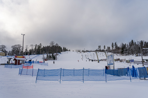 People skiing at the Messilä Ski Resort in winter. Hollola, Finland. February 7, 2023.