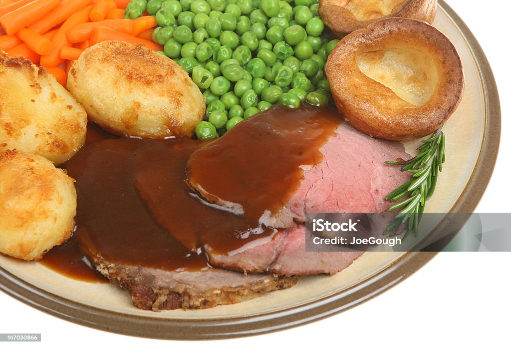 Roast Beef Dinner Traditional roast beef dinner with Yorkshire pudding and gravy. Gravy Stock Photo