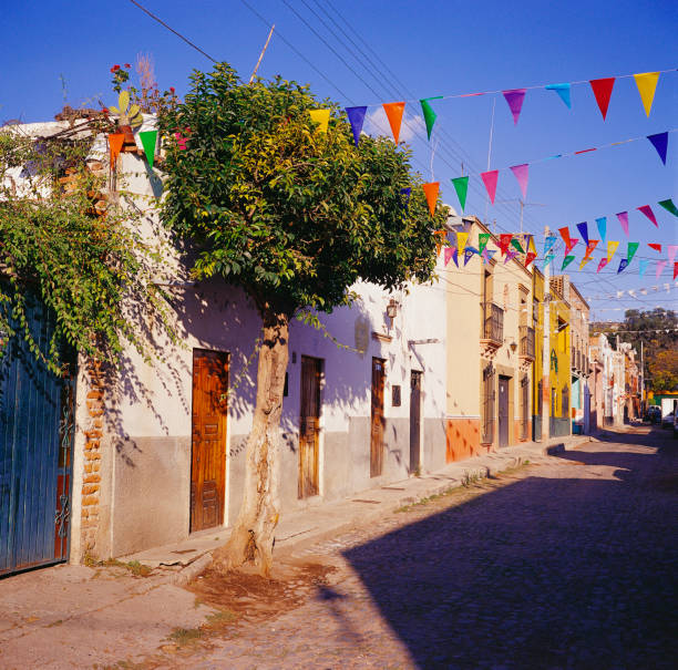 A quaint street with decorative flags hung across it