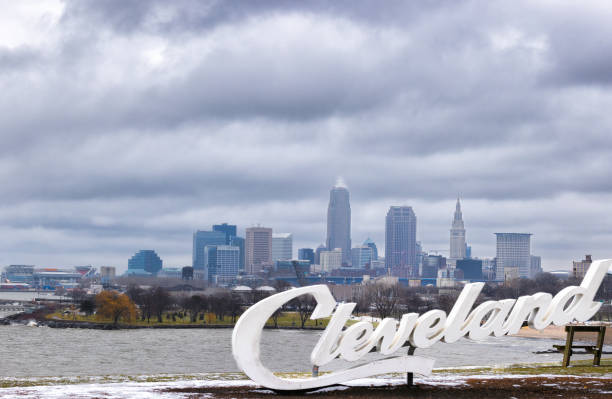 Cleveland, Ohio, United States - January 6, 2023:  Stormy winter skies over Cleveland Ohio skyline seen from Edgewater Park Cleveland sign on the shore of Lake Erie