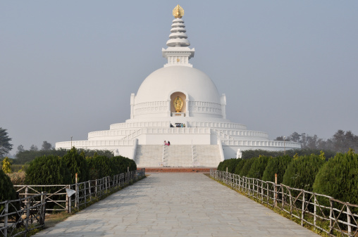 A front shot from the entrance of the white Japanese Peace Pagoda located in Lumbini, Nepal. Near the birthplace of the Buddha.
