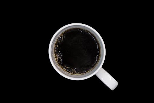 Top view of black coffee in a white cup isolated on black background