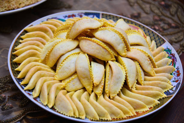 homemade sweets from gazelle horns for ramadan. close-up detail shot of fresh baked kaab el ghazal, a moroccan sweet also known as gazelle horns, halal food - gazelle imagens e fotografias de stock