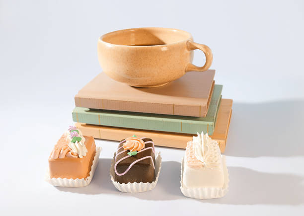 Book and Breakfast: A Cup of Espresso and Mini Pastry Delights on a Book Stack