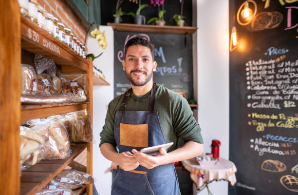 istock Bakery worker with a tablet preparing a display of freshly baked goods 1470319220