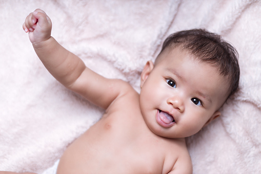 Portrait of a baby with soft blanket color background - Stpck photo