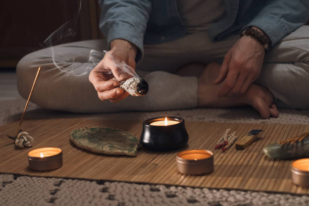 istock Man lighting incense for meditation and spiritual practice 1470321387
