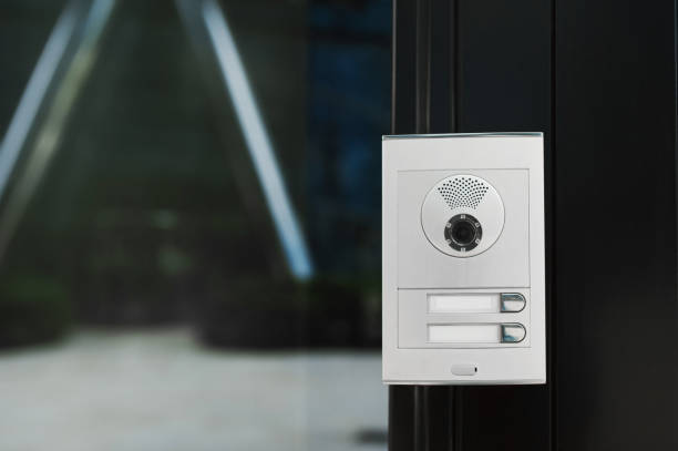 istock Modern intercom with camera hanging on door outdoors 1470322810